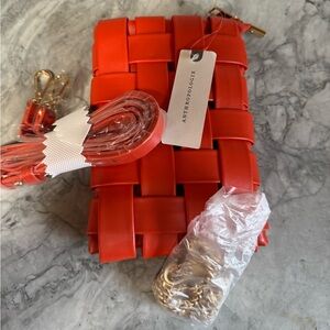 NWT Anthropologie woven phone crossbody in orangee. Originally $58